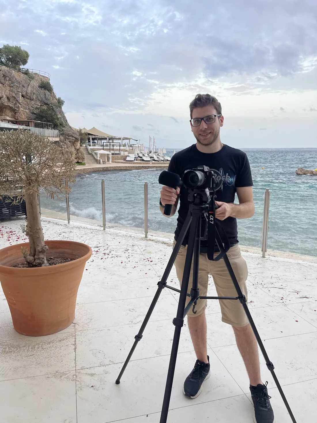 Gabriel with a camera on a tripod in Mallorca